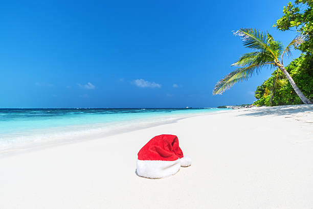 istock Santa hat at the tropical beach 591408300