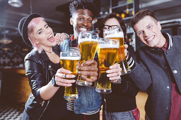 istock Happy friends toasting with beer in a pub 591408446