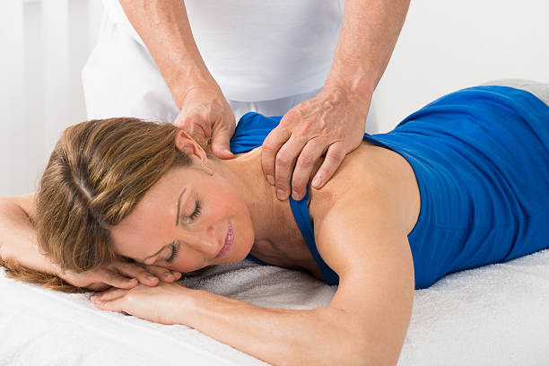 person giving massage to woman - reflexology massaging recovery sport imagens e fotografias de stock