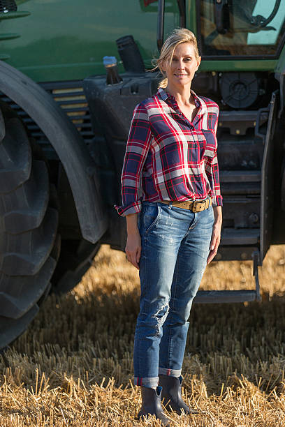 istock Female farmer and her tractor 591409606