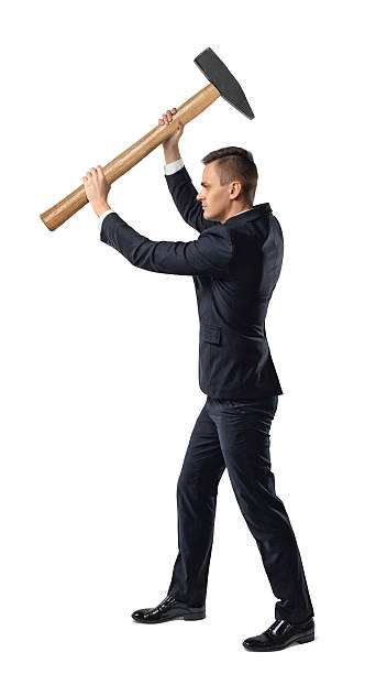 istock Businessman raising a big mallet 591409974