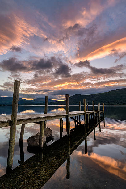istock Wooden Jetty Sunrise With Dramatic Clouds. 591412052