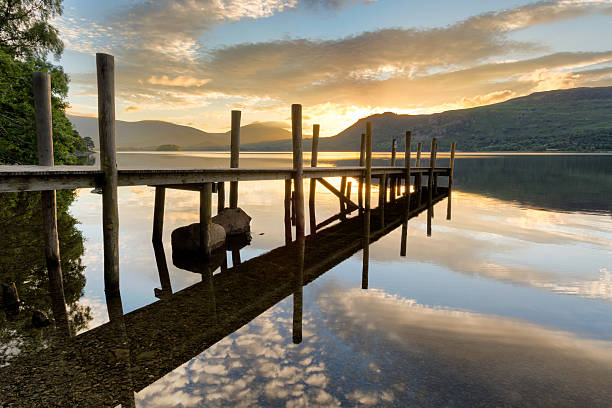 istock Tranquil Morning Reflections With Wooden Jetty. 591412092