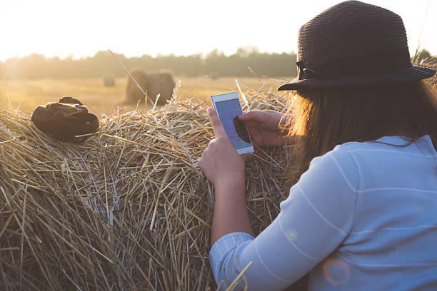 istock Girl outdoors looking at smartphone 591412502