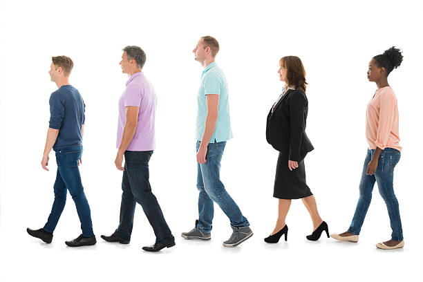 istock Creative Business People Walking With Manager In Row 591412562