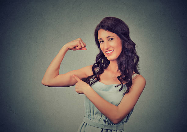 istock Fit healthy woman flexing muscles showing strength 591412678