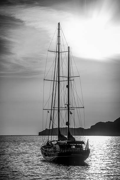 istock Old ship sailing to the sunset. 591412730