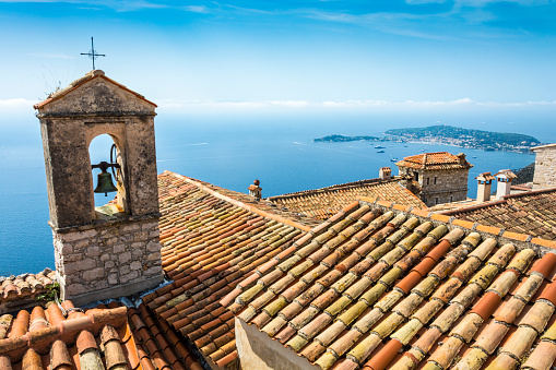 Detail of a bell tower on the Cote d'Azur Coast in France seen from Eze. The headland is Saint-Jean-Cap-Ferrat.