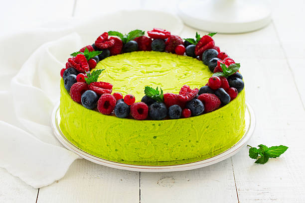 istock Home pistachio cheesecake with raspberries and blueberries. 591412994