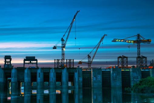 The dam, evening, construction cranes