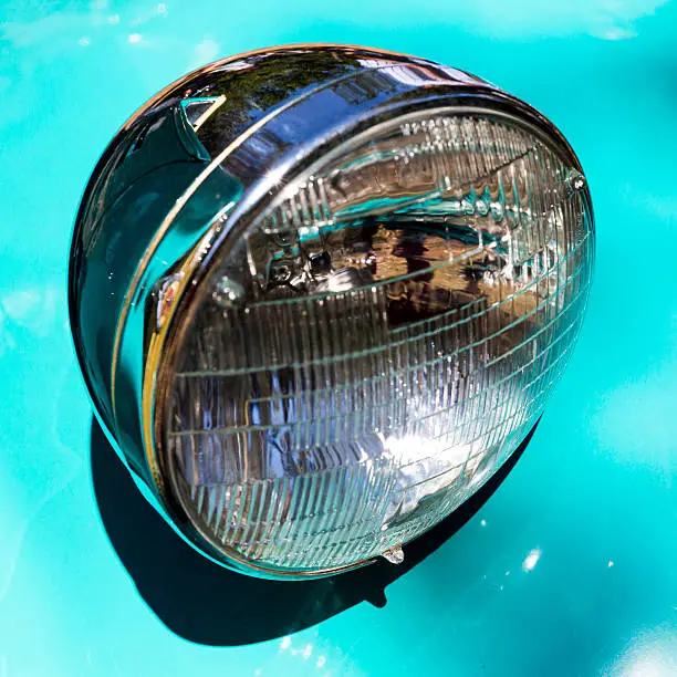 Detail of an attique car at a retro car parade. Headlights. Blue headlamp.