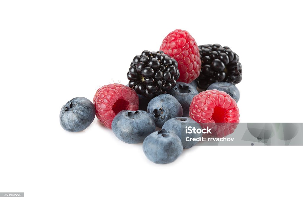 Mix of different berries on a white background Mix of berries. Raspberries, blueberries and blackberries on a white background. Isolated. Berry Fruit Stock Photo