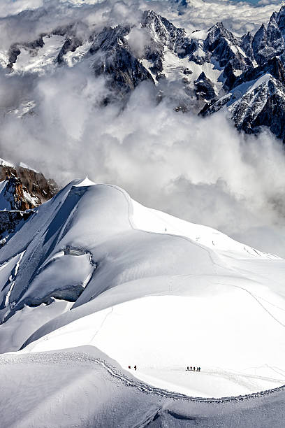 Alpinists on a snow field in the Mont Blanc Mountain Range (Haute-Savoie, France).