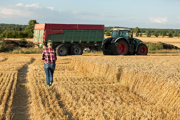 istock female farmer with tractor 591416374