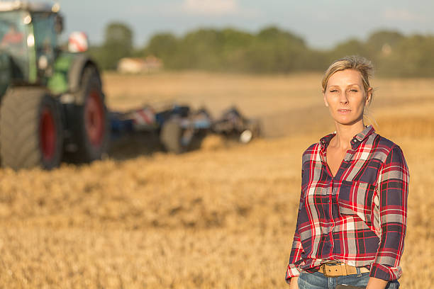 istock female farmer with tractor 591416734