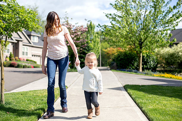 istock Beautiful single mom walking with her daughter 591416750