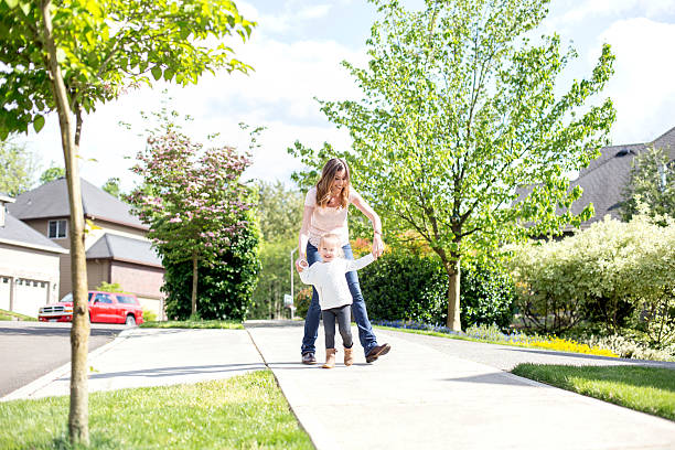 istock Beautiful single mom holding her daughters hand 591416802