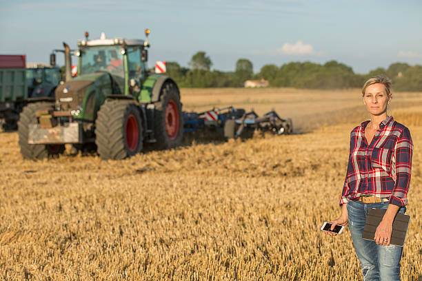 istock female farmer with tractor 591416820