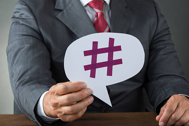 istock Businessman Showing Hashtag On Speech Bubble 591416836