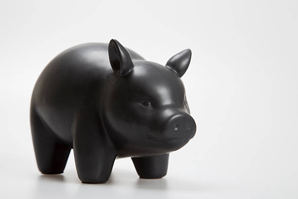istock black ceramic piggy bank on a white background 591416846