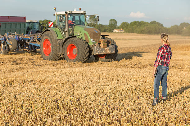 istock female farmer with tractor 591416886