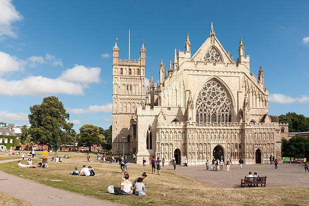 Exeter cathedral green in summer with people relaxing stock photo