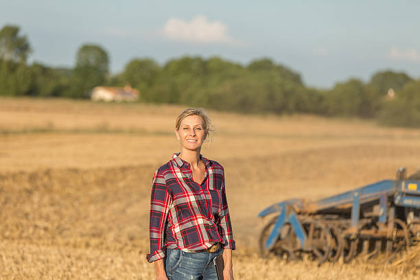 istock female farmer with tractor 591417016