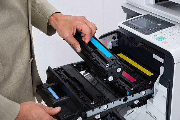 istock Businessman Fixing Cartridge In Photocopy Machine 591418312