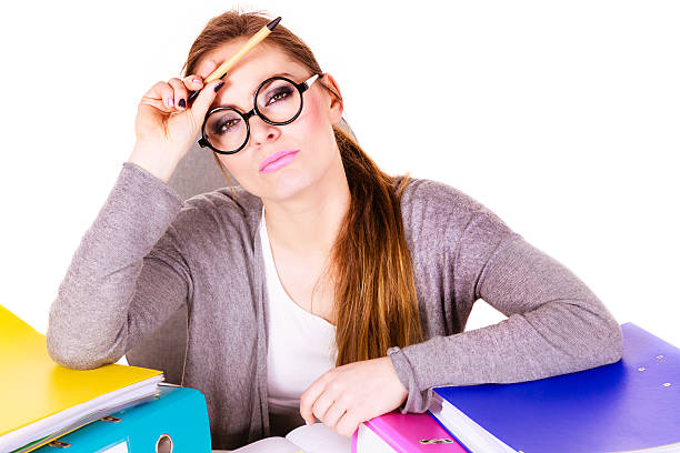 istock Woman sitting at desk in office and thinking 591418496