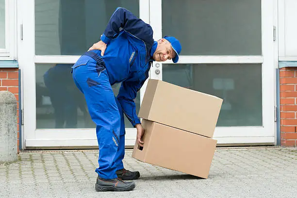 Delivery Man Suffering From Backpain While Lifting Boxes
