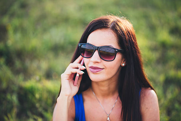 istock Young girl using phone in the nature 591420092
