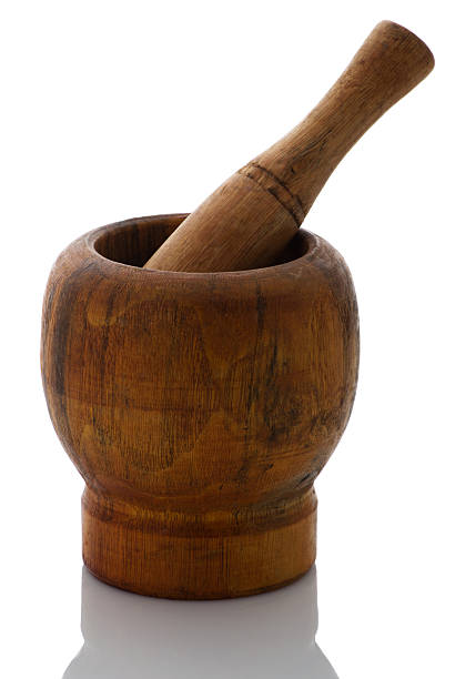 istock Wooden mortar and pestle on a white background 591421112