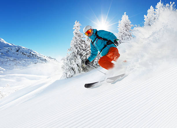 istock Skier on piste running downhill 591421530