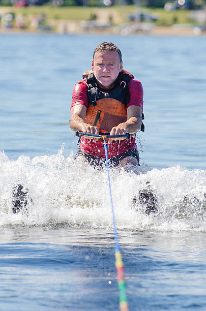 istock Man getting out of water with skis pulled by boat 591422720