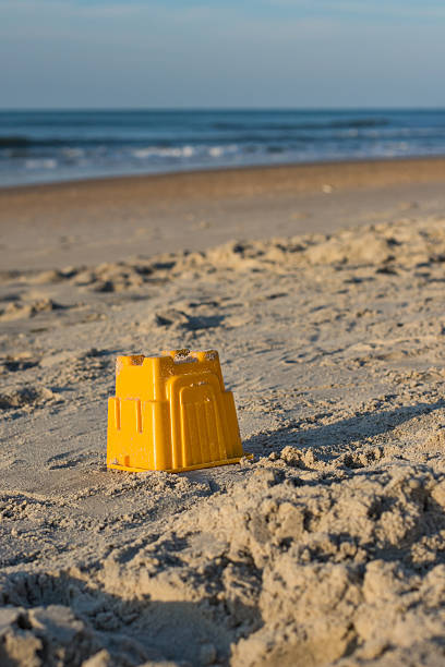 istock Sandcastle toy on the beach. 591424014