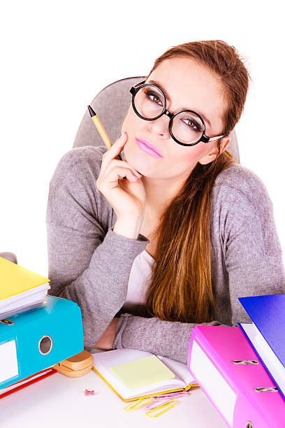 istock Woman sitting at desk in office and thinking 591424766