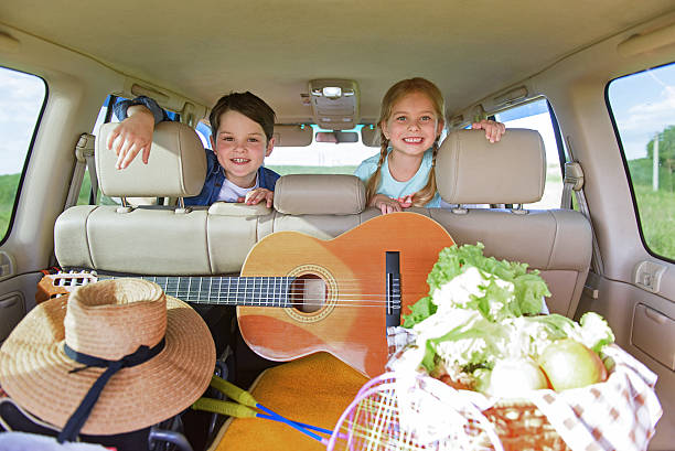 istock Happy kids sitting in car 591425140