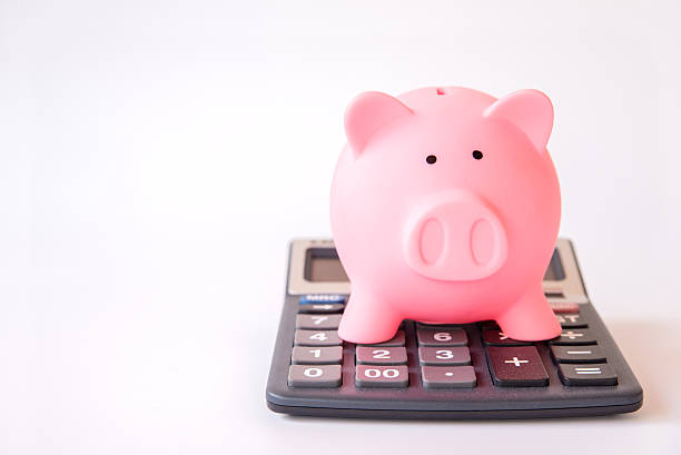 istock piggy bank and calculator showing saving concept 591426858