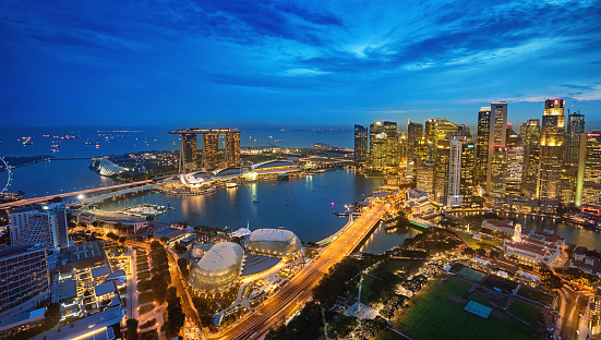 Aerial view over downtown singapore at Dusk towards the modern Business District Skyscrapers over The Singapore City Hall, the National Gallery of Singapore, Padang Singapore and the Singapore Cricket Club, Marina Bay and Marina Bay Sands Hotel in the background. Singapore City, Downtown - Marina Bay  District, Asia. XXXL Photo, made with Sony A7RII.