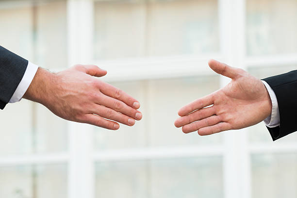 istock Businessman Shaking Hands With Partner 591429418