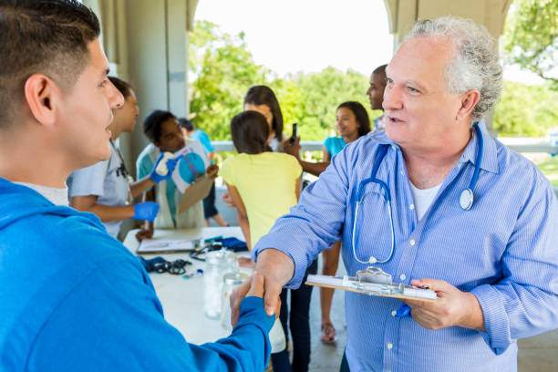istock Volunteering Senior Doctor shaking hands with patient 591430678