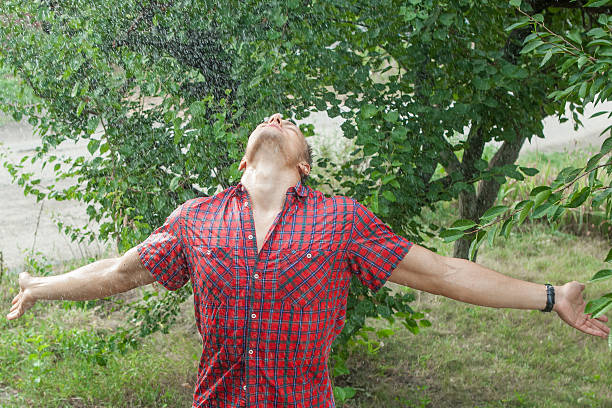istock Sexy young man wet in rain 591431250