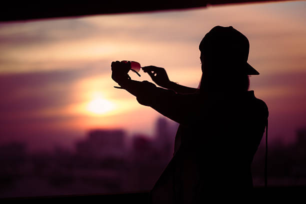 istock Girl shooting backlit Looking through solar glasses 591431838