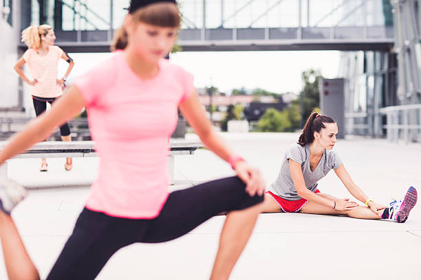 istock group of friends stretching before run 591433508