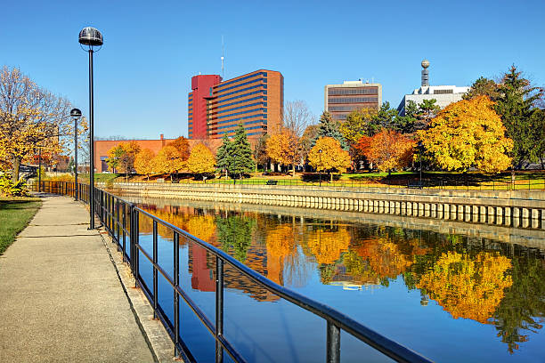 Autumn colors reflecting on the Flint River in Downtown Flint Michigan Beautiful Autumn colors reflecting on the Flint River in Downtown Flint Michigan flint michigan stock pictures, royalty-free photos & images