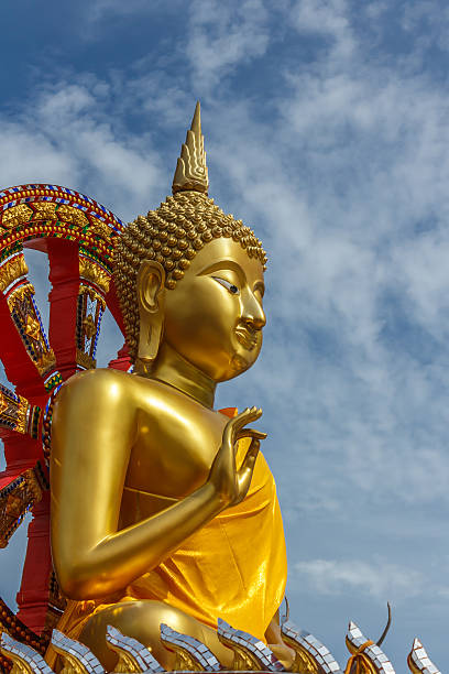 istock Golden Buddha and blue sky. 591434870
