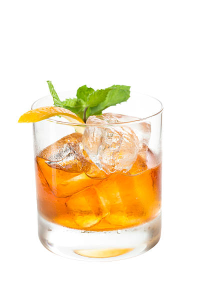 istock Whisky with lemon and mint isolated on white 591434878