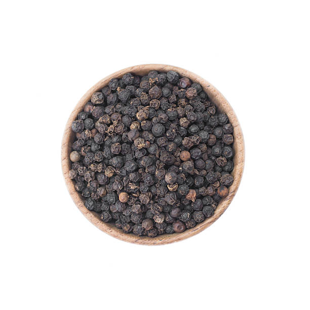 istock Black pepper in wooden bowl isolated on white background 591435364