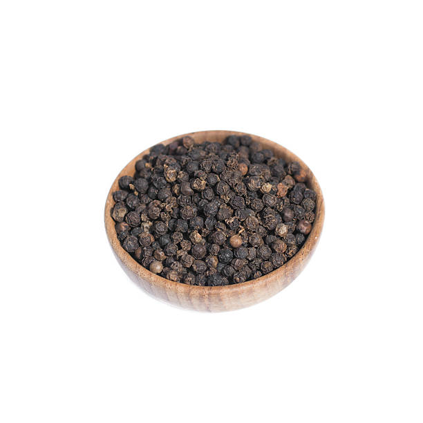 istock Black pepper in wooden bowl isolated on white background 591435434