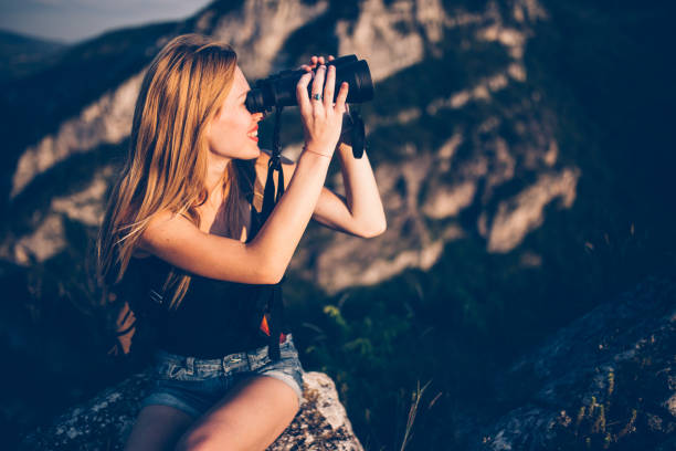 istock Pretty woman with binoculars 591436212